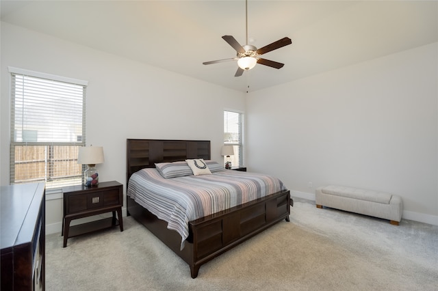 bedroom featuring ceiling fan, baseboards, and light carpet