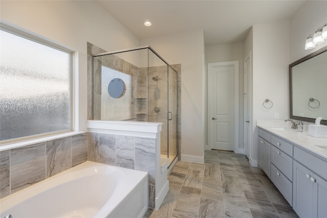 full bathroom with double vanity, a shower stall, a garden tub, and a sink