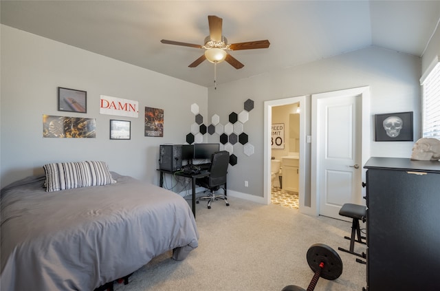 bedroom with a ceiling fan, ensuite bath, baseboards, light colored carpet, and vaulted ceiling