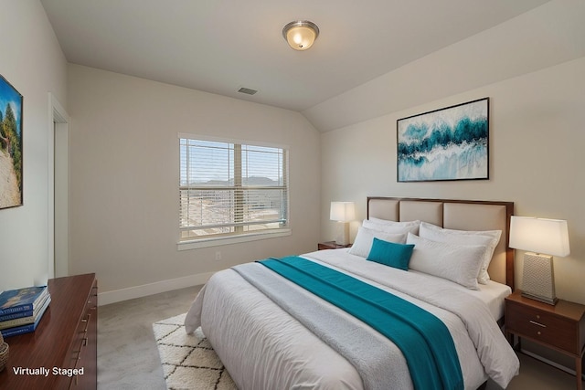 carpeted bedroom featuring baseboards, lofted ceiling, and visible vents