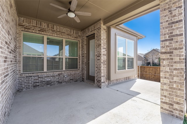 view of patio / terrace with a ceiling fan and fence