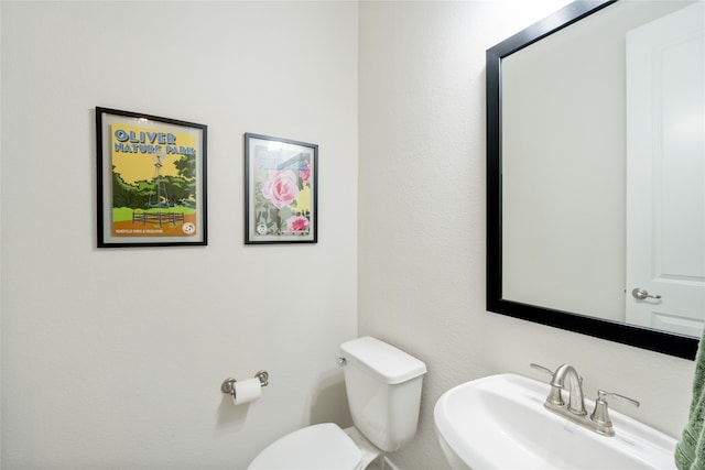 bathroom with toilet and a sink