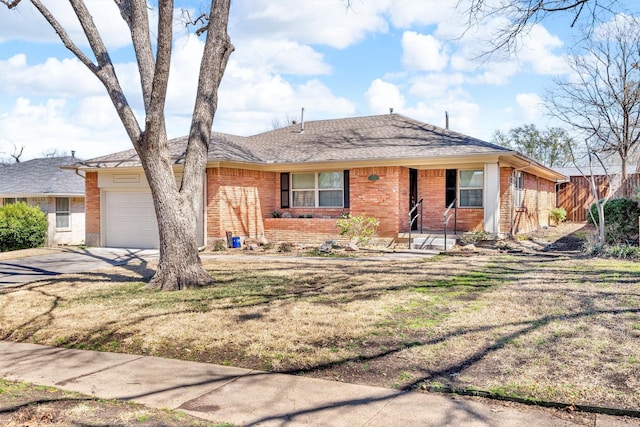 ranch-style home featuring concrete driveway, a garage, brick siding, and a front lawn