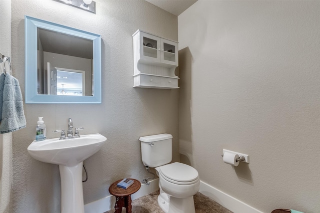 bathroom featuring toilet and a sink