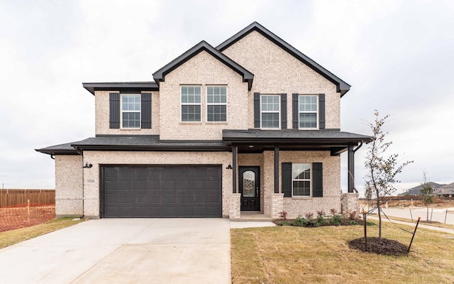 craftsman inspired home with brick siding, an attached garage, fence, a front yard, and driveway