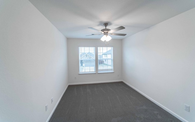 unfurnished room featuring a ceiling fan, baseboards, and dark colored carpet