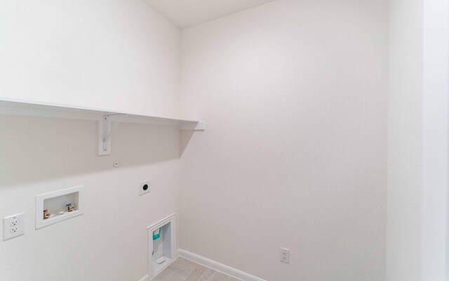 clothes washing area with hookup for a washing machine, baseboards, gas dryer hookup, laundry area, and electric dryer hookup