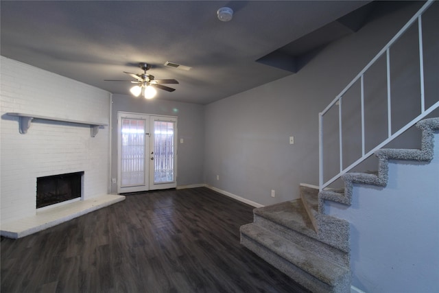 unfurnished living room featuring wood finished floors, stairway, french doors, and visible vents