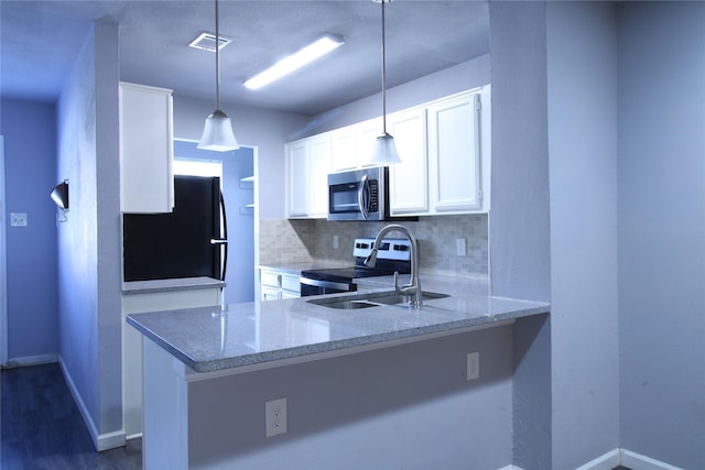 kitchen with visible vents, backsplash, light stone counters, appliances with stainless steel finishes, and white cabinetry