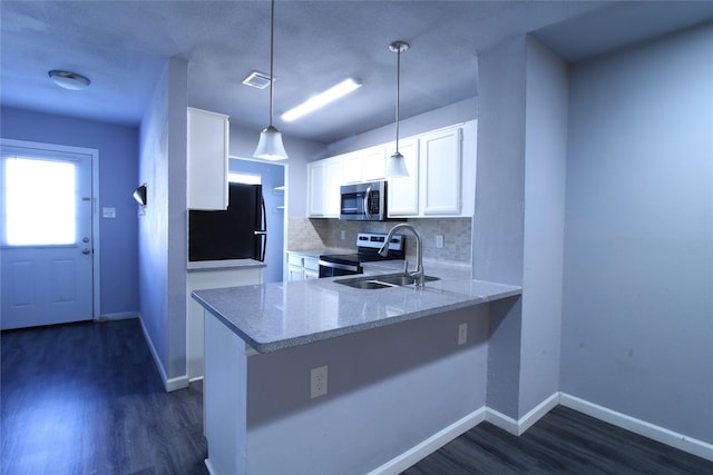 kitchen featuring light stone countertops, visible vents, a sink, stainless steel appliances, and backsplash