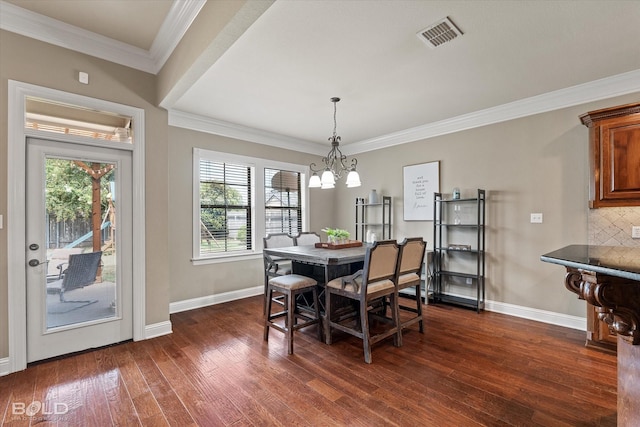 dining room with visible vents, crown molding, baseboards, and dark wood-style flooring