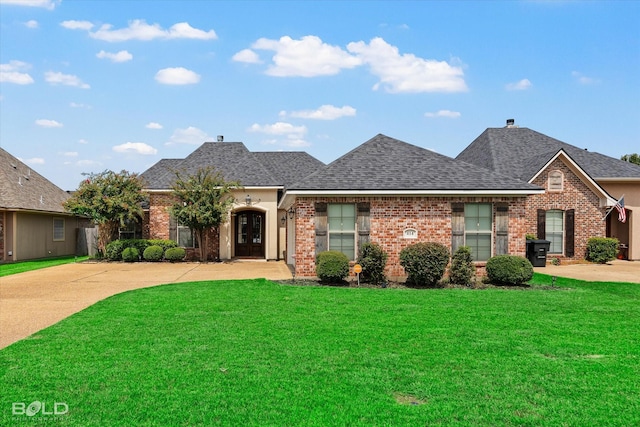 french country inspired facade featuring a front lawn, brick siding, and roof with shingles