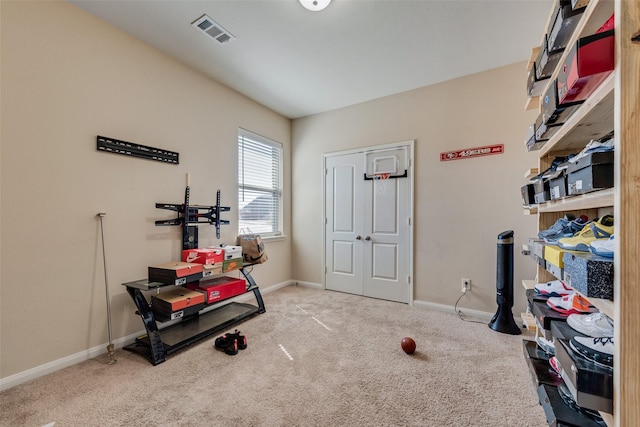 exercise room with visible vents, baseboards, and carpet