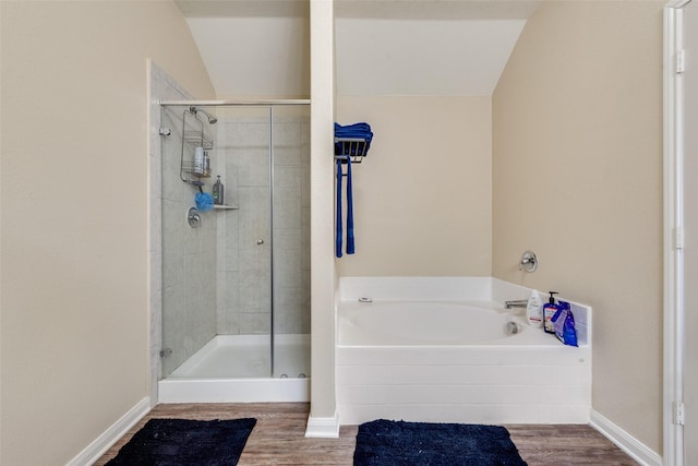 full bath with a stall shower, baseboards, a garden tub, and wood finished floors