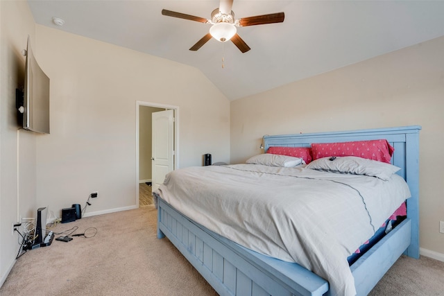 bedroom featuring light carpet, a ceiling fan, baseboards, and vaulted ceiling