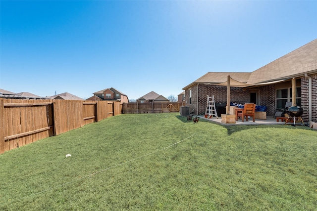 view of yard with a patio, central AC unit, and a fenced backyard