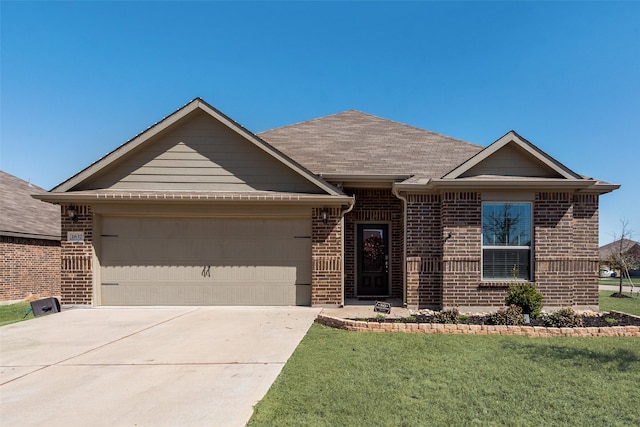 ranch-style home with brick siding, an attached garage, concrete driveway, and a front lawn