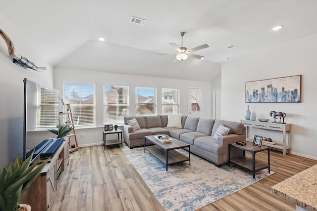 living room featuring lofted ceiling, recessed lighting, visible vents, and light wood-type flooring