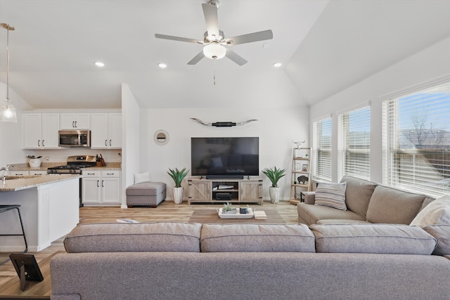 living room featuring lofted ceiling, recessed lighting, and light wood-style floors