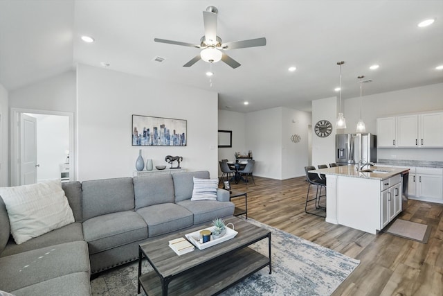 living area featuring visible vents, recessed lighting, a ceiling fan, and wood finished floors