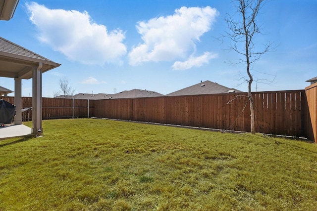 view of yard with a patio area and a fenced backyard