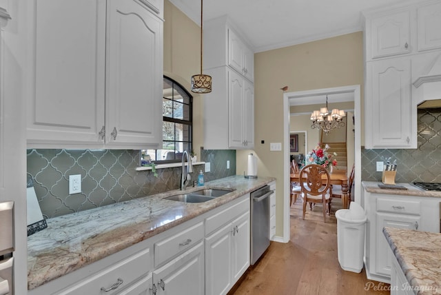 kitchen with a sink, light wood-type flooring, appliances with stainless steel finishes, and white cabinets