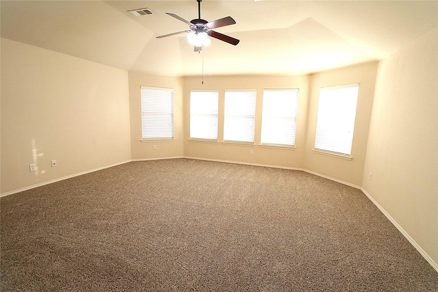 carpeted empty room featuring vaulted ceiling, baseboards, visible vents, and ceiling fan