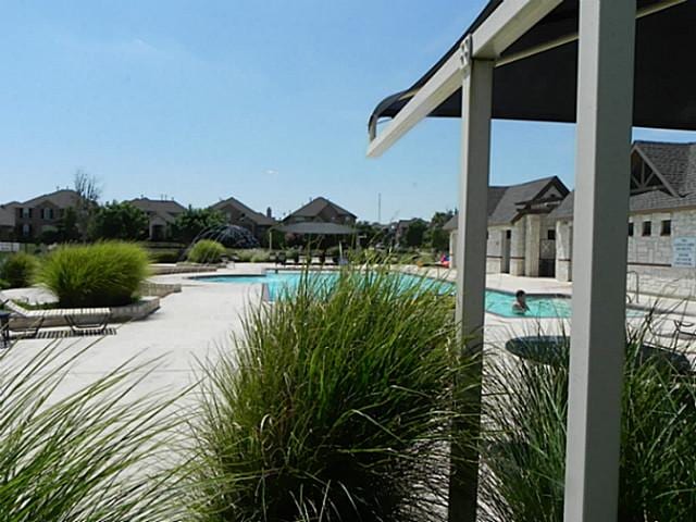 community pool featuring a patio area