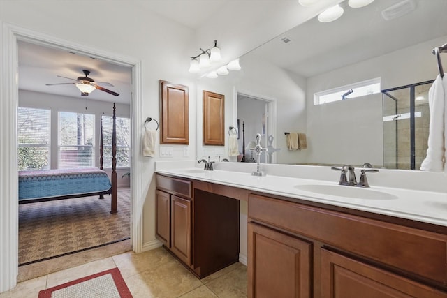 ensuite bathroom with double vanity, tile patterned floors, ensuite bath, and a sink