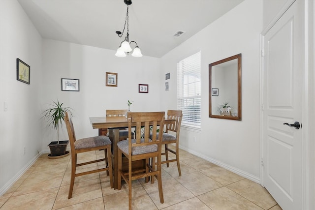 dining space with light tile patterned floors, visible vents, a notable chandelier, and baseboards