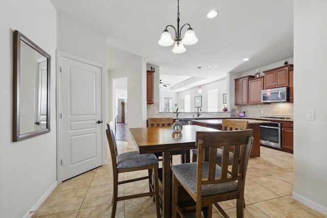 dining room featuring an inviting chandelier, light tile patterned floors, recessed lighting, and baseboards