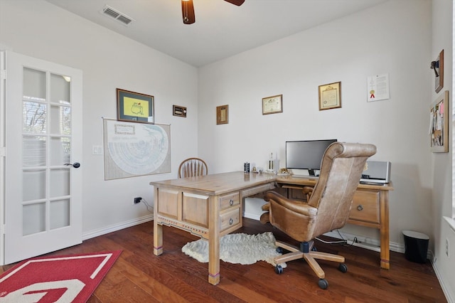 home office featuring visible vents, a ceiling fan, baseboards, and wood finished floors