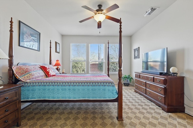 bedroom with a ceiling fan, light colored carpet, and visible vents