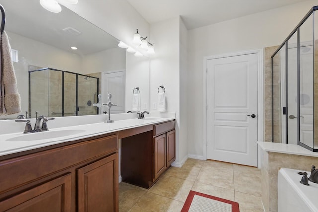 full bathroom with tile patterned flooring, double vanity, a stall shower, and a sink