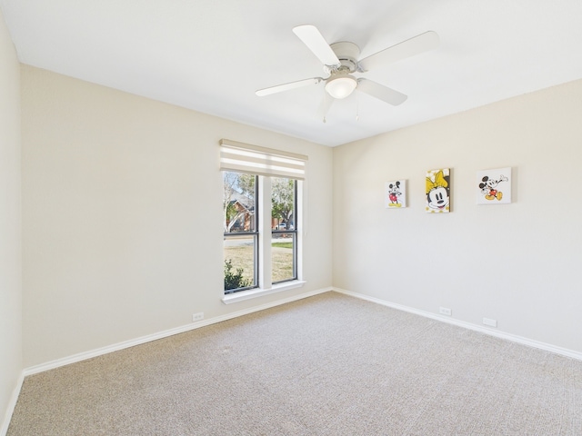 empty room with baseboards, carpet floors, and ceiling fan