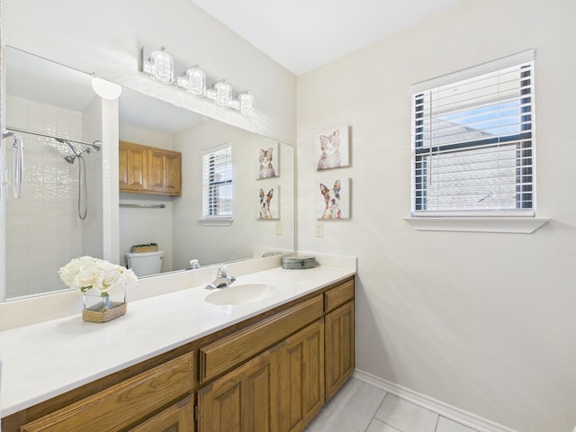 full bath featuring baseboards, toilet, a tile shower, tile patterned floors, and vanity