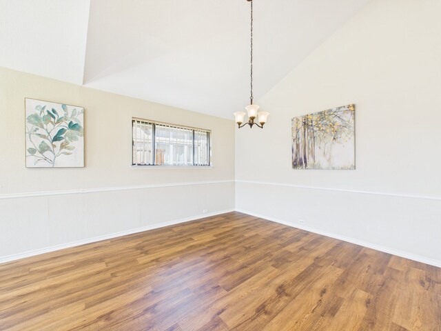 unfurnished living room featuring visible vents, ceiling fan with notable chandelier, light wood-style flooring, and vaulted ceiling