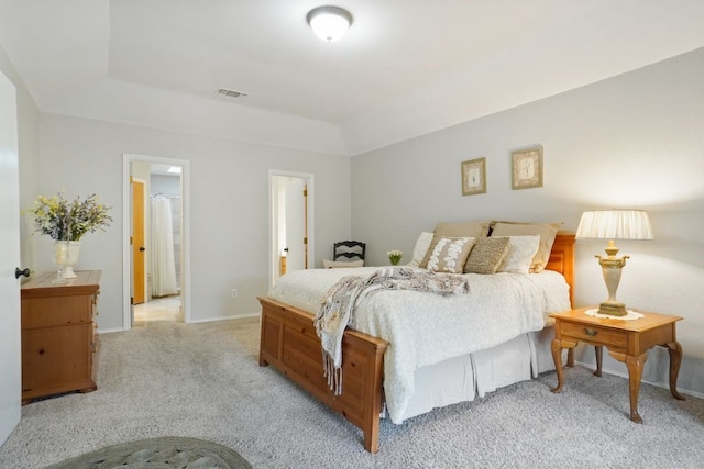 bedroom with baseboards, visible vents, and light carpet