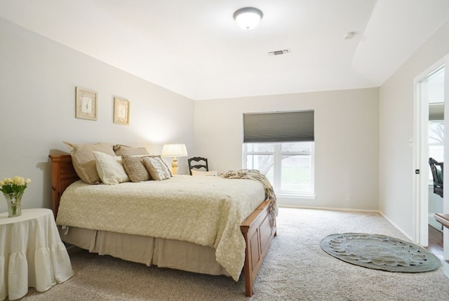 bedroom with light colored carpet, visible vents, and baseboards