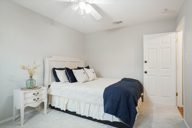 carpeted bedroom with visible vents, baseboards, and ceiling fan