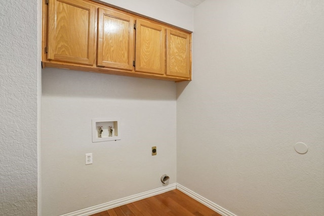 laundry area with baseboards, washer hookup, dark wood-style floors, cabinet space, and electric dryer hookup