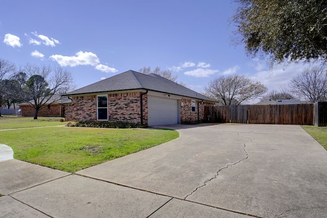 view of side of property with fence, driveway, an attached garage, a lawn, and brick siding