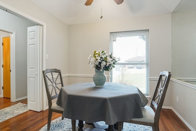 dining room with a ceiling fan, baseboards, and wood finished floors