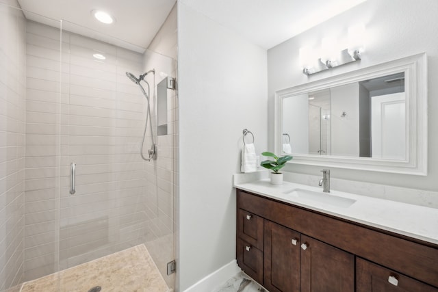 bathroom featuring marble finish floor, a stall shower, recessed lighting, baseboards, and vanity