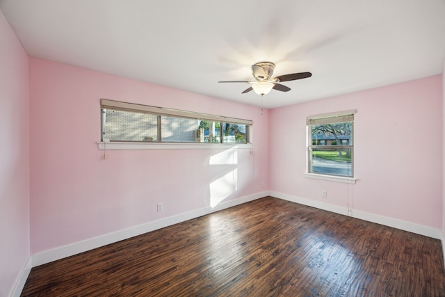 empty room featuring wood finished floors, baseboards, and ceiling fan