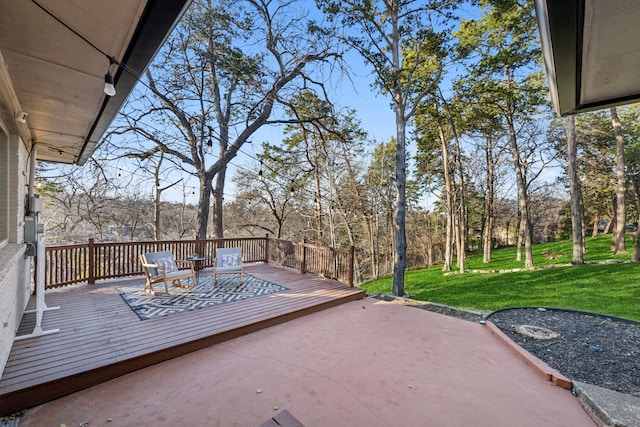 wooden deck featuring a lawn and a patio area