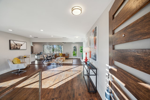 living room featuring hardwood / wood-style flooring, recessed lighting, and baseboards