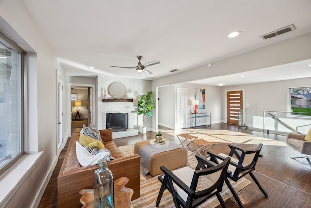 living area featuring wood finished floors, recessed lighting, a fireplace, and visible vents