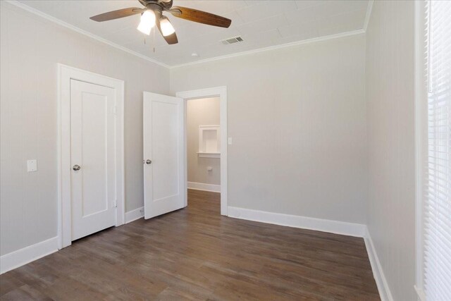 unfurnished bedroom with visible vents, baseboards, ornamental molding, wood finished floors, and a ceiling fan