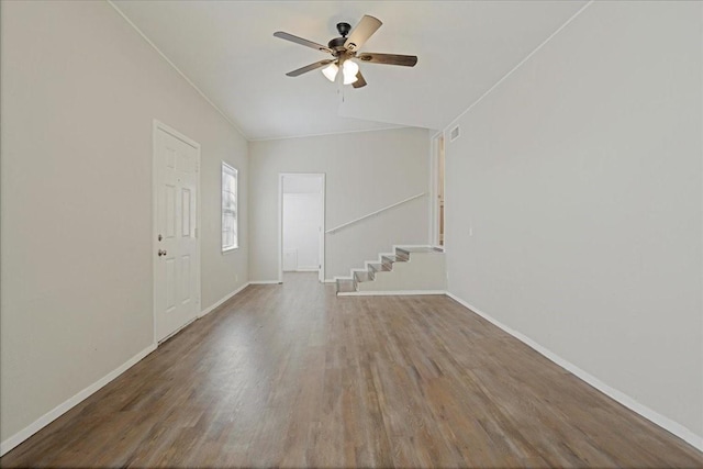 entryway with visible vents, wood finished floors, stairway, baseboards, and ceiling fan